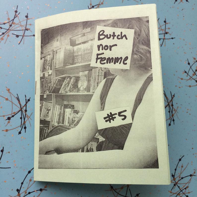 photo of zine on 1950s looking formica. cover is photo of a person typing against a bookstore background with their face covered by the title