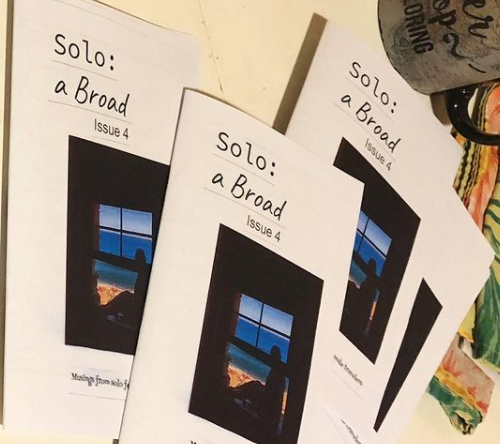 zine covers: color photo of a person looking out a window at the ocean