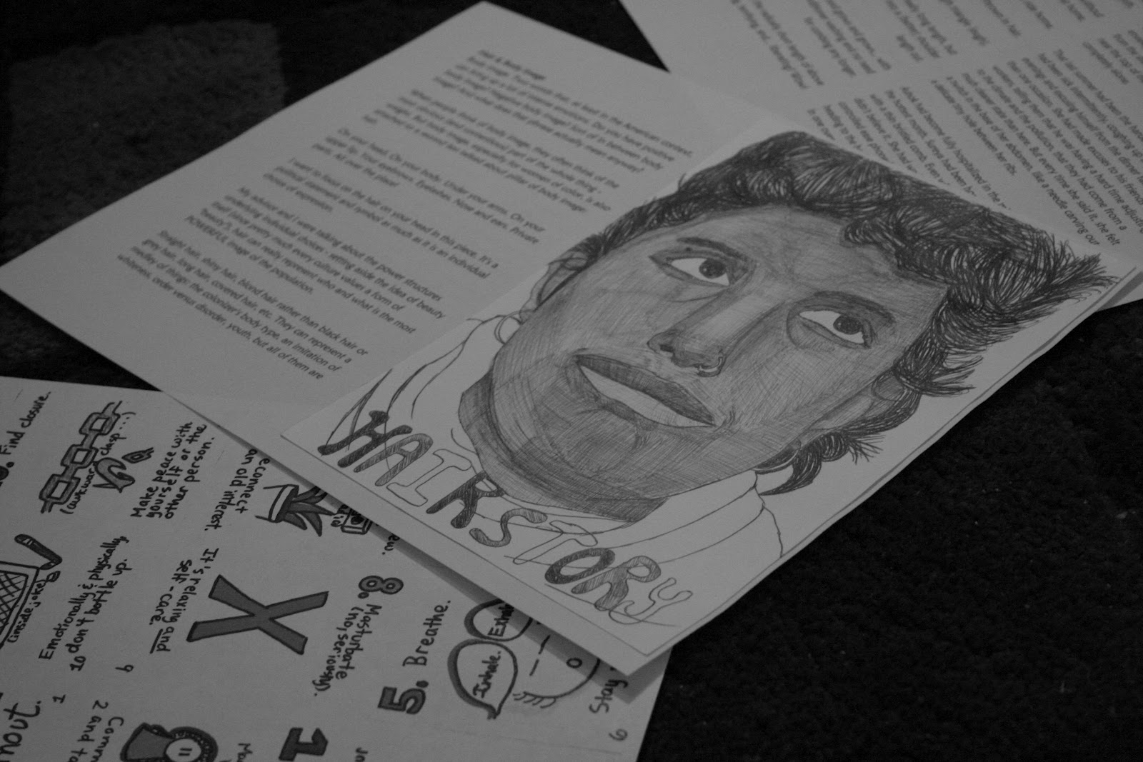 photo of zine in layout form: text on back cover, self portrait of the creator on the front cover