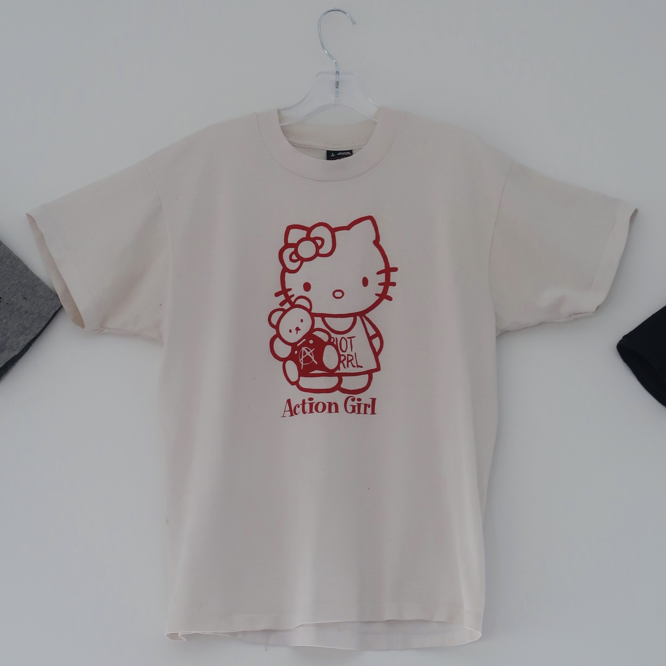 Hello Kitty holding teddy with anarchist symbol printed in red on white t shirt