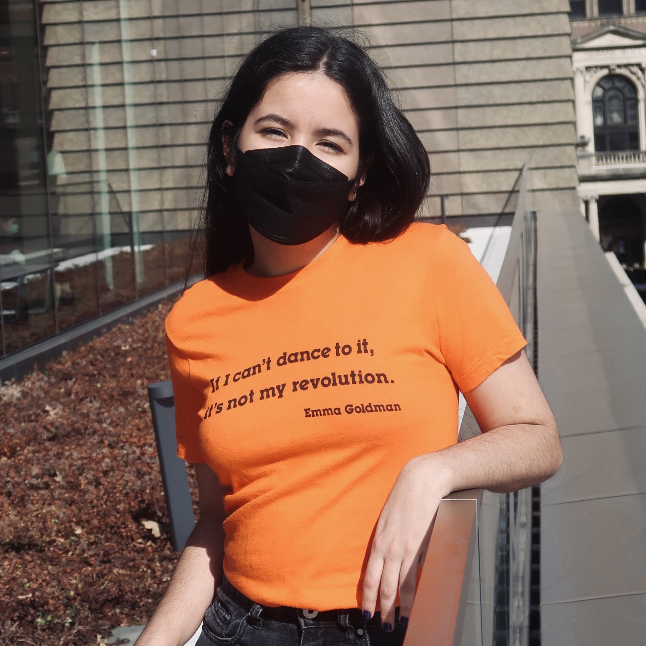 Stident wearing orange shirt with Emma Goldman quote