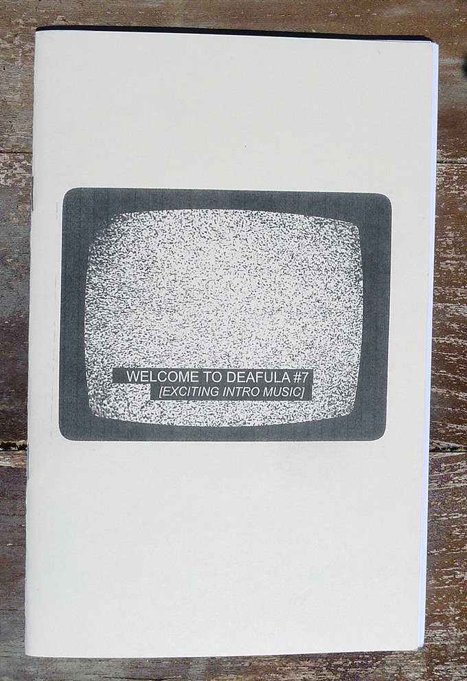 photograph of zine cover on a brown background. The cover features a CRT TV screen with closed captioning reading, "WELCOME TO DEAFULA #7 / EXCITING INTRO MUSIC"