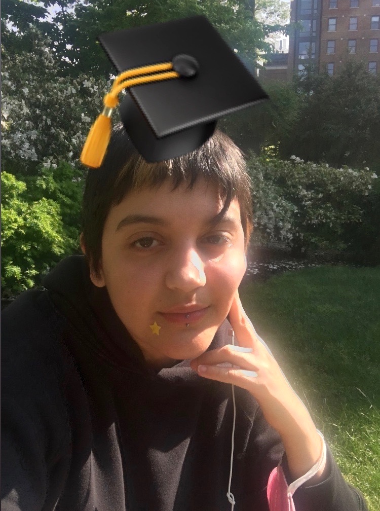 photo of Claudia Acosta with a mortarboard graphic on their head
