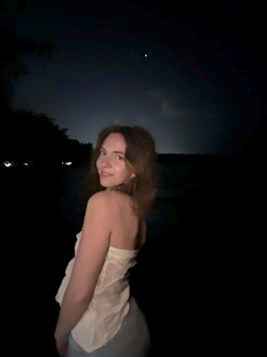 photo of Olivia in a fancy dress, night sky behind her