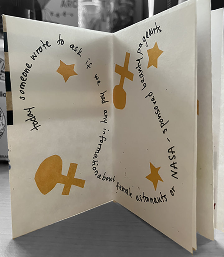 photo of a page of a zine that reads "today someone wrote to ask if we had an information about female astronauts or NASA-sponsored beauty pageants" illustrated by venus symbols and stars