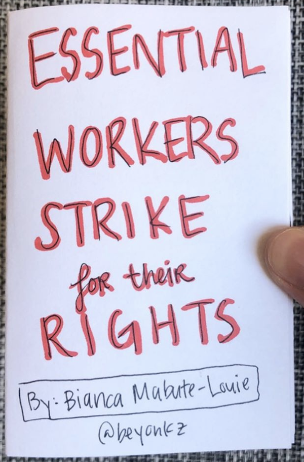 photo of the zine Essential Workers Strike for Their Rights, and the creator's thumb holding the zine