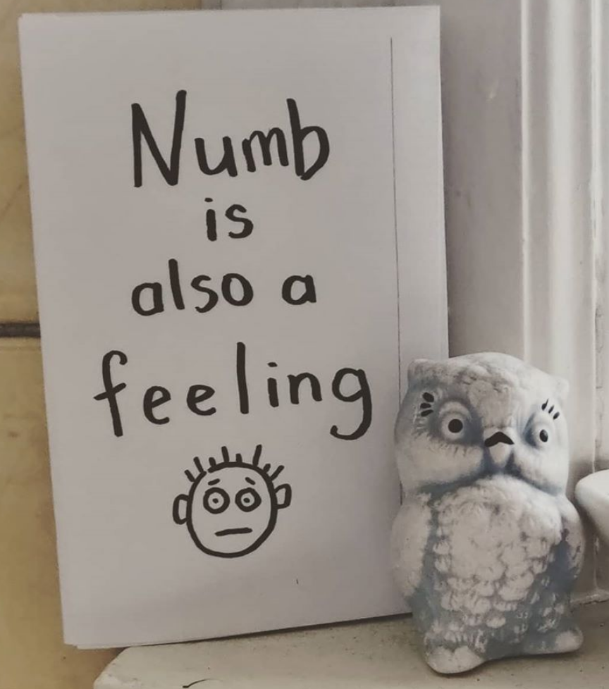 cover of Numb Is Also a Feeling: handwritten title, stick figure face at the bottom