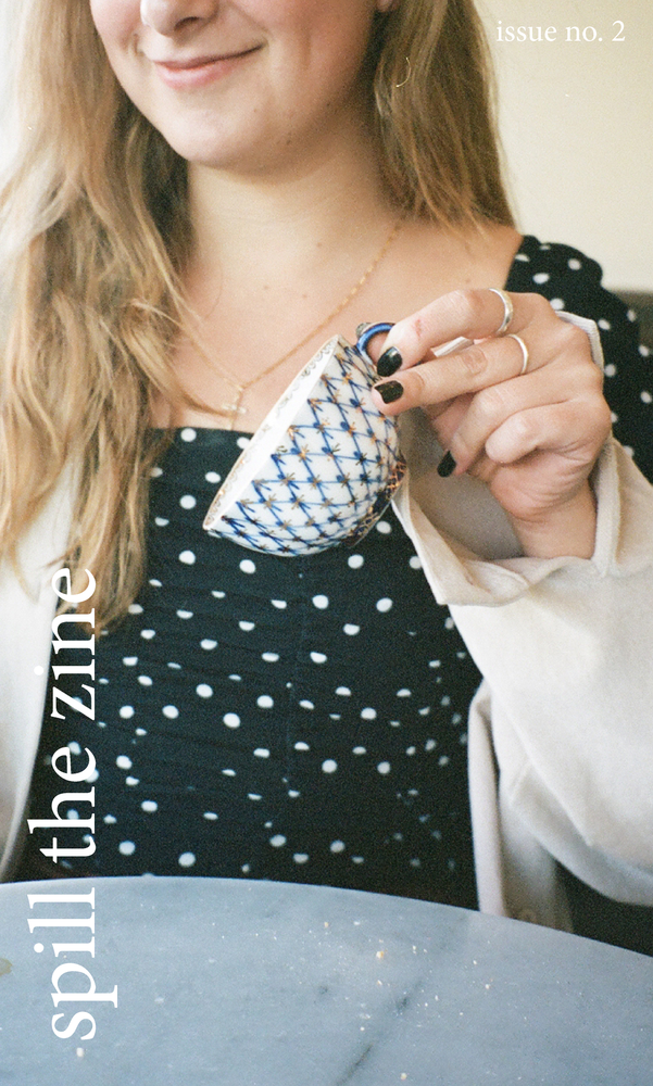 glossy zine cover: blonde person spilling a tea cup