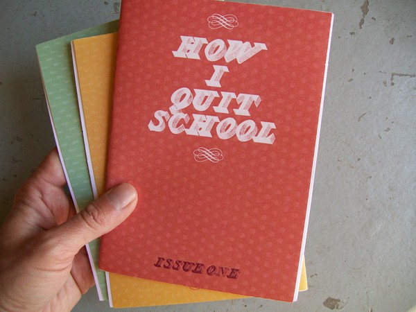 photo:a person's hand holding issues 1-3 of How I Quit School zine